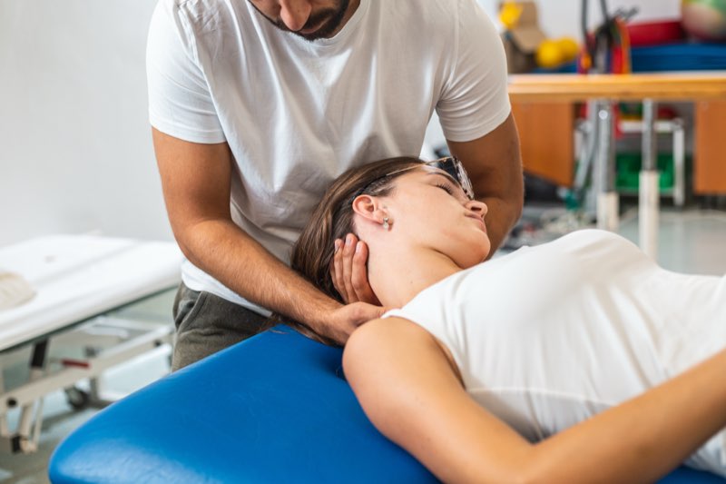 A chiropractor performing a spinal adjustment on a patient